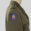 Khaki army woollen jacket with belt which has a metal buckle, rising sun badge on each lapel.