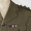 Khaki army woollen jacket with belt which has a metal buckle, rising sun badge on each lapel.