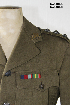 Khaki army woollen jacket with belt which has a metal buckle, rising sun badge on each lapel.