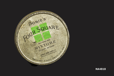 Round grey coloured with silver coloured lid (badly pitted). Printing on tin 'Dobies Four Square (overprinted on design of 4 green squares 2 top 2 bottom).
