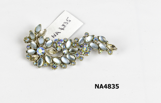 Flower spray brooch of grey and blue stones. 