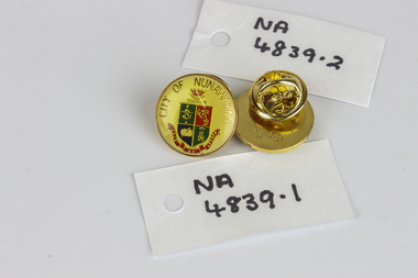 2 small lapel badges.