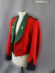Red woollen cropped jacket with green wool lapels and black cuffs and epaulets.