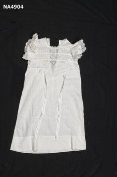 White child's long dress with lace top.