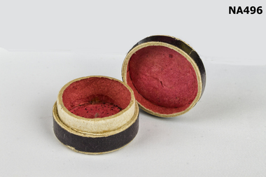 Very small round pill box.