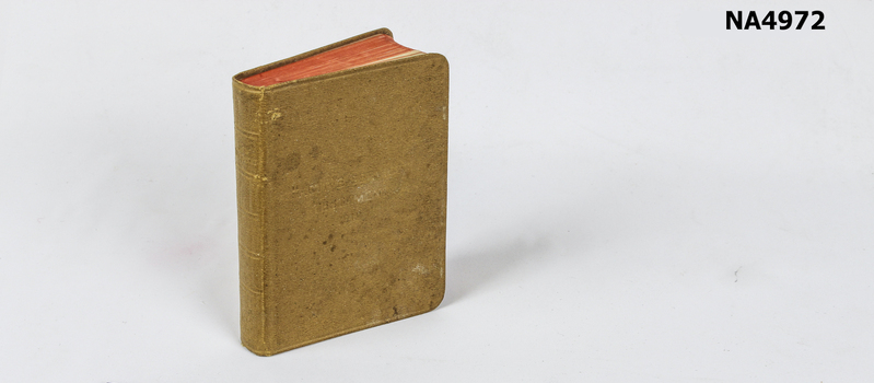 Pocket-sized New Testament. Buff-coloured, hard-cover, pages edged red. 