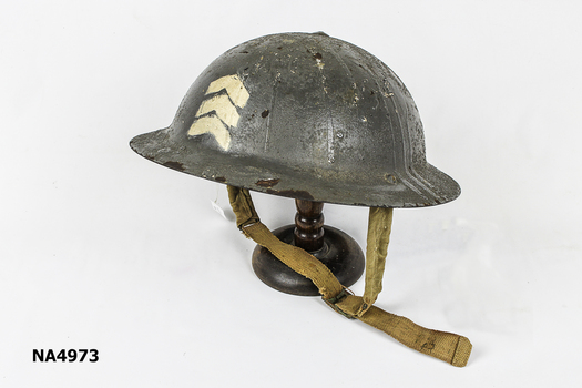 Oval-shaped, domed metal helmet. 3 white chevrons printed on front of helmet. 