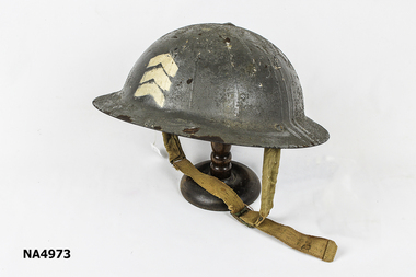 Oval-shaped, domed metal helmet. 3 white chevrons printed on front of helmet. 