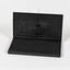 A  black plastic case containing a black ink pad. 