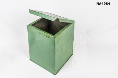 A green cube shaped biscuit tin.