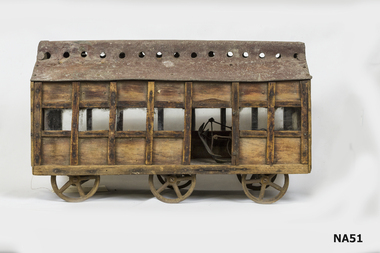 Wooden carriage with metal roof.