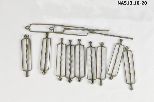 Water Wave Set comprising:  1 dish, 6 curved combs, 1 packet pins, 1 box containing hair net and 13 large hair pins. A total of 22 items.
