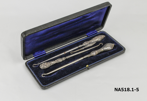 Button hook set - black oblong box lined with dark blue satin and velvet 