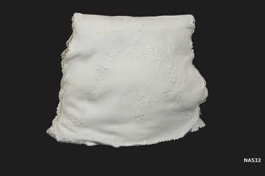 White embroidered tea cosy with quilted lining.