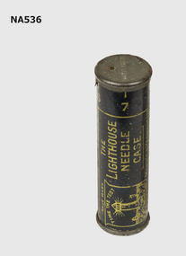 Metal cylinder containing needles. 