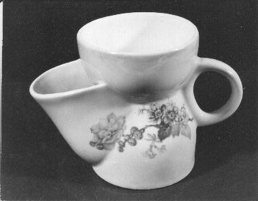 White shaving mug with orange edging and flower decoration. Cup on top is perforated to allow for shaving brush.