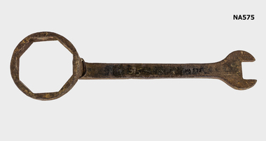 An iron wrench used to tighten caps nuts of wooden wagon wheels.  