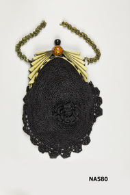 Black cotton crocheted bag attached to cream fan shaped bone frame.