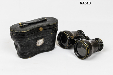 Small black opera glasses in black leather case shaped to fit