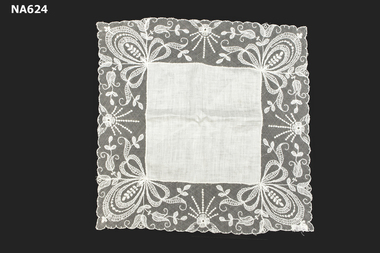 White linen handkerchief with deep lace border.