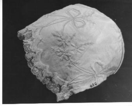 Cream silk baby bonnet lace edged and embroidered in cream
