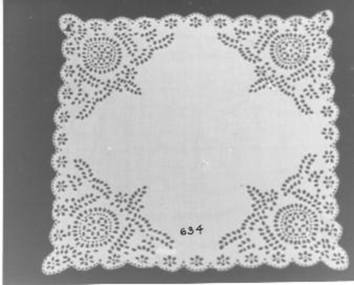 White cloth with Broderie Anglais border used to cover baby's face from sun and insects