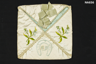  Satin bag in four sections with one section open as flap. 