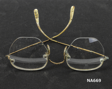 Wire framed spectacles with bifocal lens