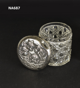 Silver top crystal jar engraved with angel faces. 