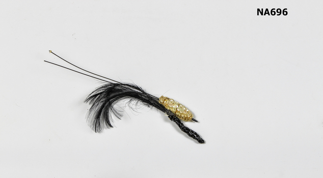 Hat decoration with white sequins and black feathers