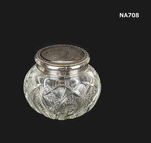 Cut glass container with silver lid used for creams