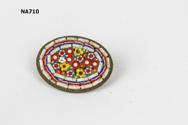 small brooch with ceramic decoration