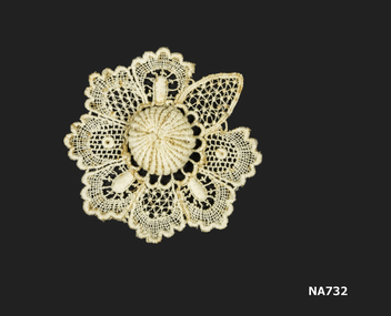 Round piece of cream lace with raised centre.