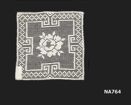 doyley made of filet lace with flower design in centre