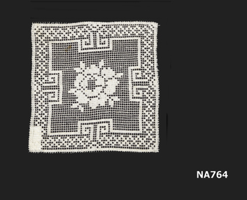 doyley made of filet lace with flower design in centre