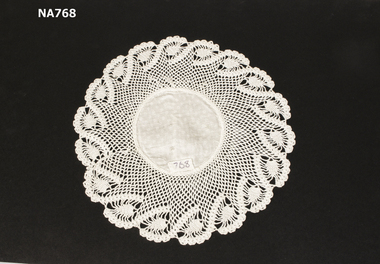 White cotton doyley with deep crocheted lace edging