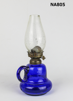 British Finger Lamp with dark blue glass base and handle. Mouth blown. Would have used kerosene. 1880- 1910.