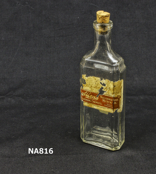 Clear glass medicine bottle with cork stopper. Label - Allens Dispensing Chemist, Whitehorse Road, Mitcham