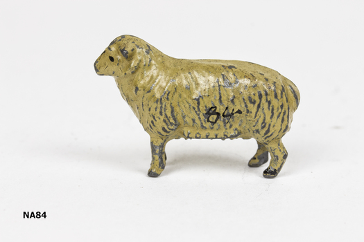 Brown painted metal sheep with black feet.