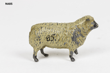 Brown painted metal sheep with black nose and black feet.