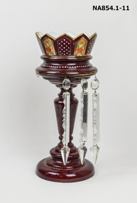 Ornamental ruby glass lustre with ten faceted prism teardrop vase. 