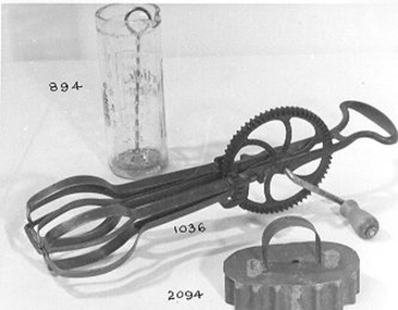 Glass phial marked 'Horlick's Mixer' in red with measurements in ounces and grammes. Metal plunger mixed the Horlick's chocolate with the milk