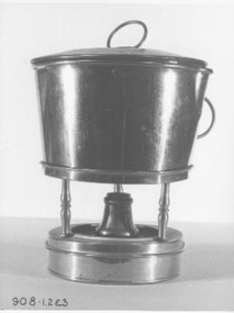 Yellow metal collapsible spirit stove. Folds into container with lid and handles.