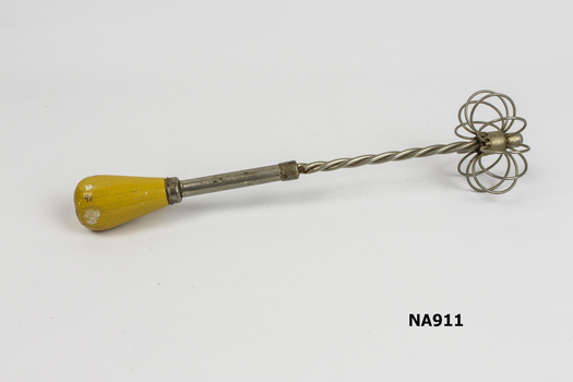 Metal whisk for beating food. Wooden handle