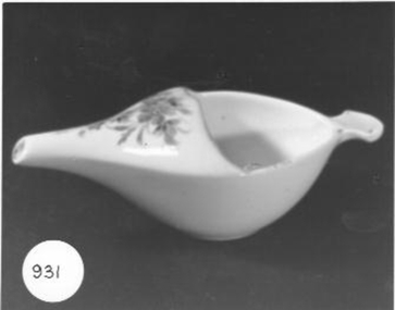 White china invalid feeding cup with flowered design. Handle and spout and half covered.