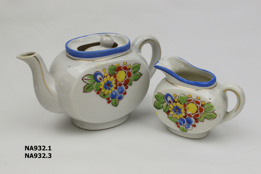 Child's china tea set - white with blue edge and flowered pattern. Comprising: tea pot with lid, milk jug with one handle, 1 cup, 1 bowl, 1 oval plate, 1 oval plate, 3 saucers, 5 plates.