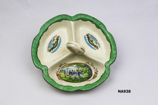 Savoury dish with three compartments and finger ring handle. 