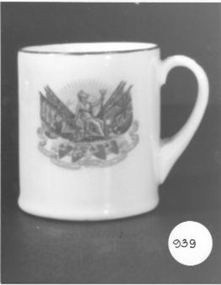 Small cup with Brittania holding flags on one side and poem lauding King on other side. No date
