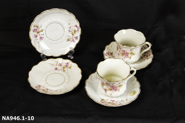  Four cups and six saucers - white bone china with pink flowered decoration. 