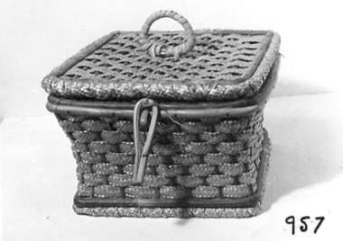 Physical description  Woven cane sewing basket with lid attached by cord. 
